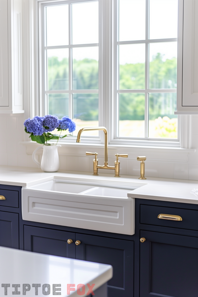 gold brass faucet white farmhouse sink navy blue cabinets white countertops white windows modern kitchen layout